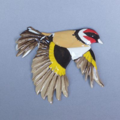 Miniature chardonneret en vol